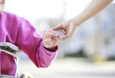 Woman holding elderly woman's hand