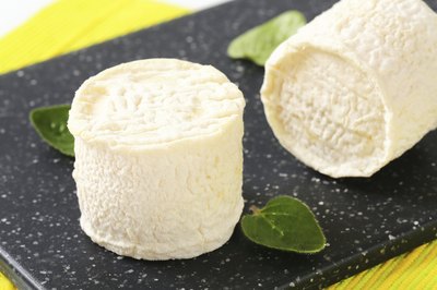 Fresh goat cheese on cutting board.