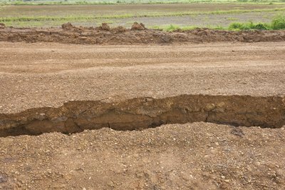 A large split in sandy soil from an earthquake.