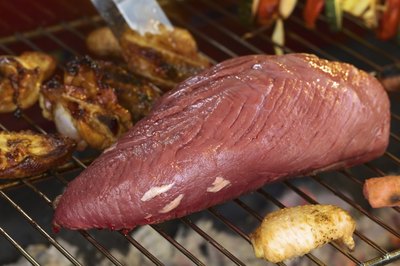Tri-tip roast and chicken wings on BBQ grill