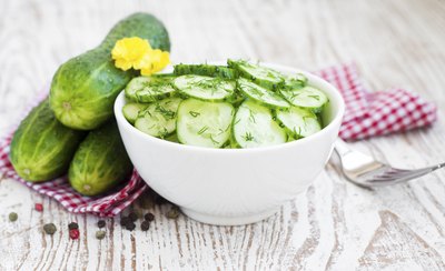 Cucumbers beside a cucumber dill salad.