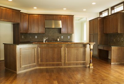 Kitchen with cherry wood cabinets and flooring