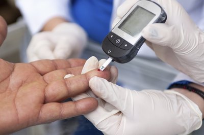 A patient gets their blood sugar tested.
