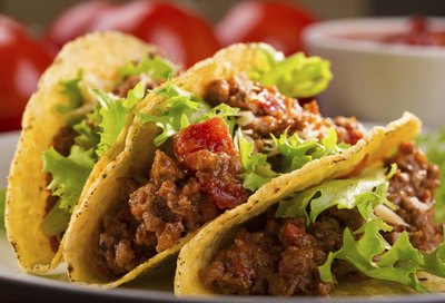 Tacos with lettuce and tomato.