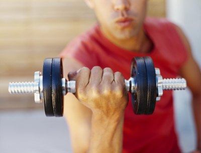 A man lifts weights at a gym.
