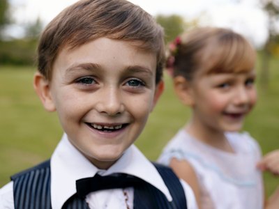 A boy and girl wearing fancy clothes.