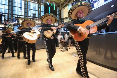 A mariachi band strolling through a building.