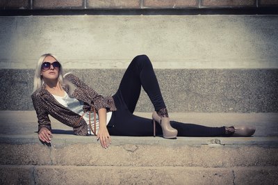Young woman wearing black trousers with beige heels