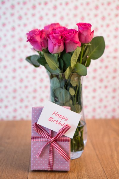 Bouquet of flowers, card and present