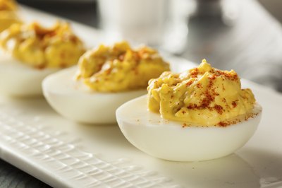 Deviled eggs being served on a modern plate.