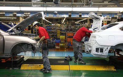 Workers assemble vehicles in Japan