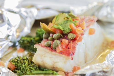 Pink snapper with capers cooked in aluminum foil.