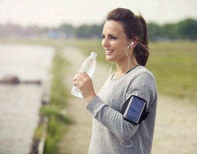Woman drinking from bottle of water.