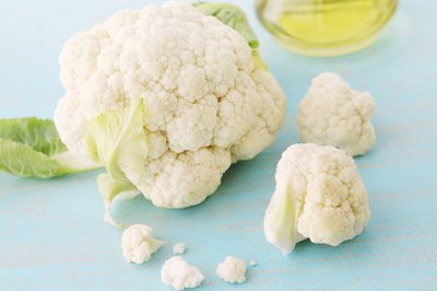 Fresh cauliflower on a painted blue table.
