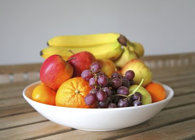 A bowl filled with an assortment of fruits.