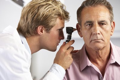 Physician examining patient's ear