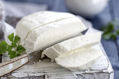 Sliced mozzarella cheese on cutting board