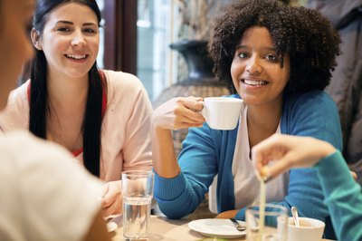 A group of friends hang out in a coffee shop.
