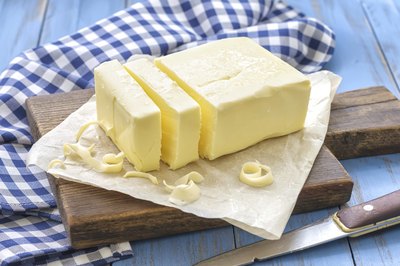 A 1/2lb of butter on a cutting board.