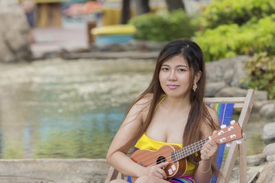 Young woman playing the ukelele.