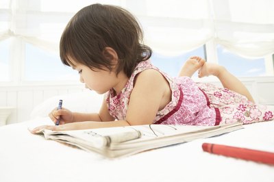 Young girl with a coloring book.