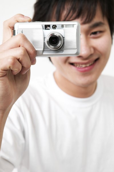 Boy holding digital camera