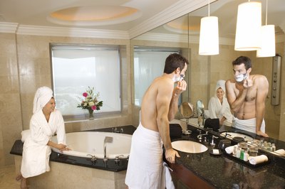 Couple in large hotel bathroom.