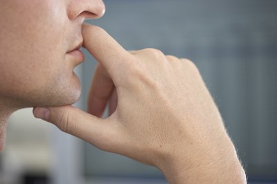 Man holding mouth