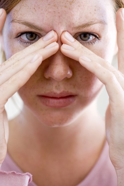 Woman holding nose