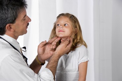Doctor checking a child's lymph node