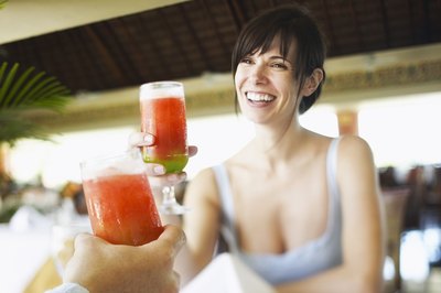 Woman toasting with strawberry daiquiri