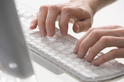 Person typing on keyboard
