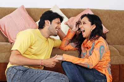 couple laughing while sharing answers