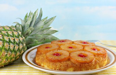 Pineapple upside down cake next to a pineapple