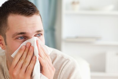 man blowing his nose