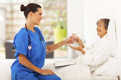elderly woman drinking water in hospital