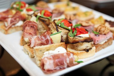 Assortment of tapas appetizers on small plate.