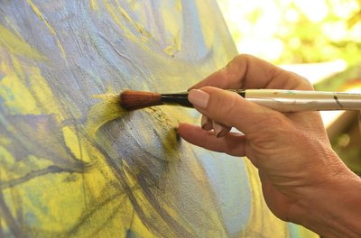 Hands of a woman painting.