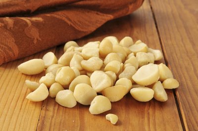Macadamia nuts on a wooden table.