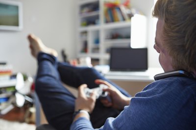 Teen on cell phone playing a video game