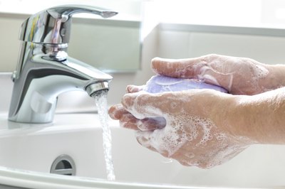 Close-up of hands being washed