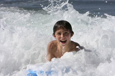 Boy playing in ocean
