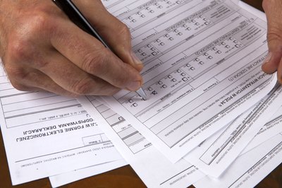 A man is filling out business forms.