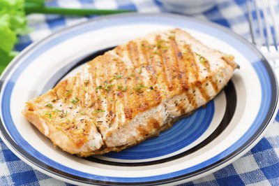 Grilled salmon filet on small dish.