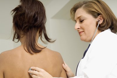 Doctor sounding a woman's back