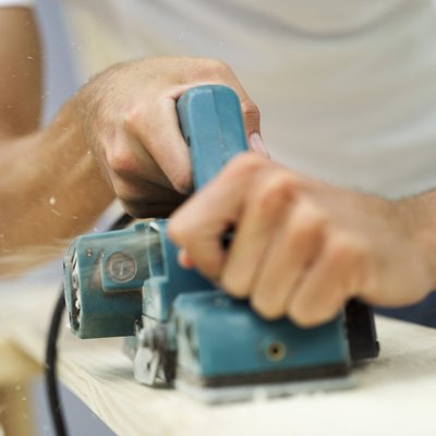 Close-up of a woman using a power sander