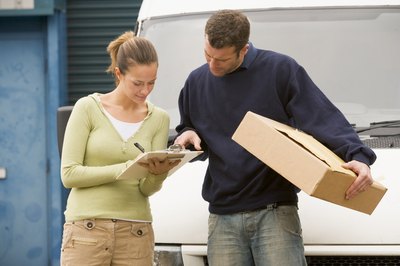 Manager going over papework with delivery driver