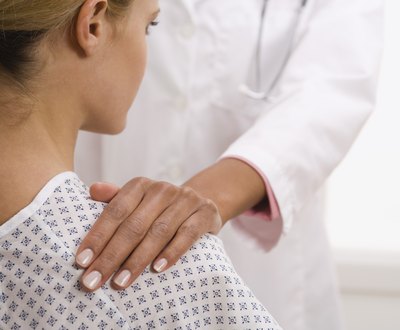 Doctor examining shoulder