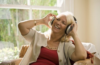 Mature woman wearing headphones