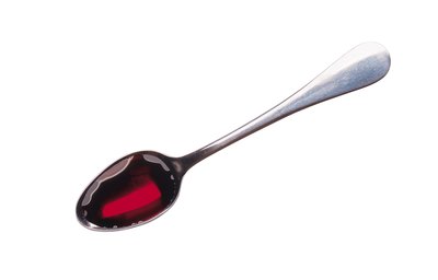 Cough medicine on spoon.